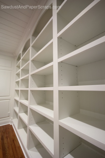 library with white built ins and wainscoting